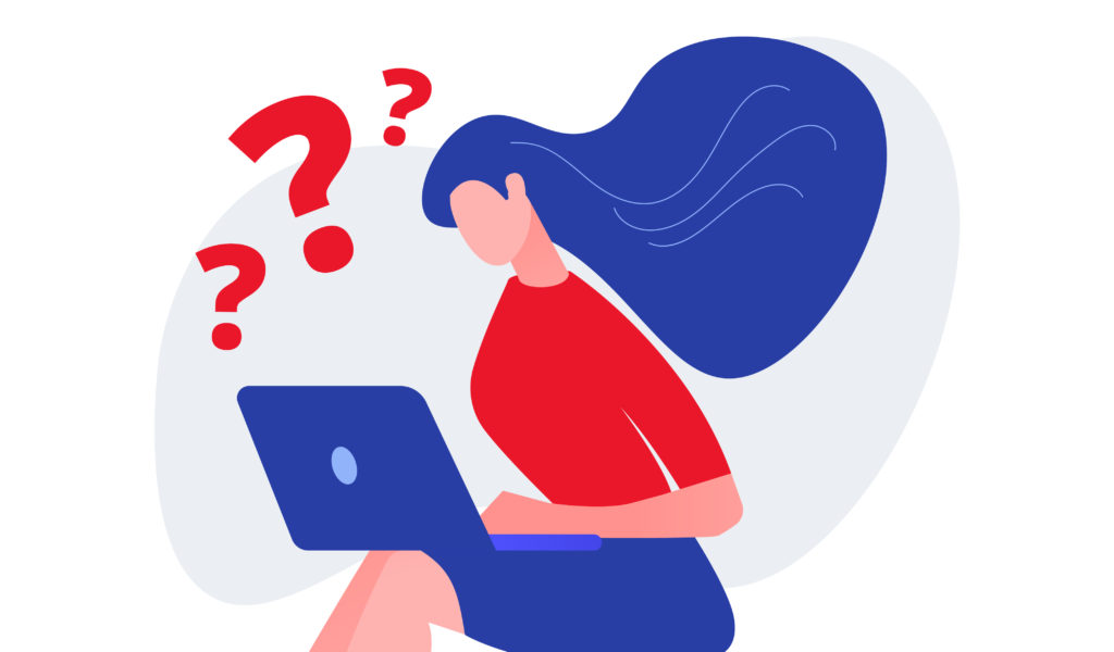 A woman with a laptop thinking about a question.